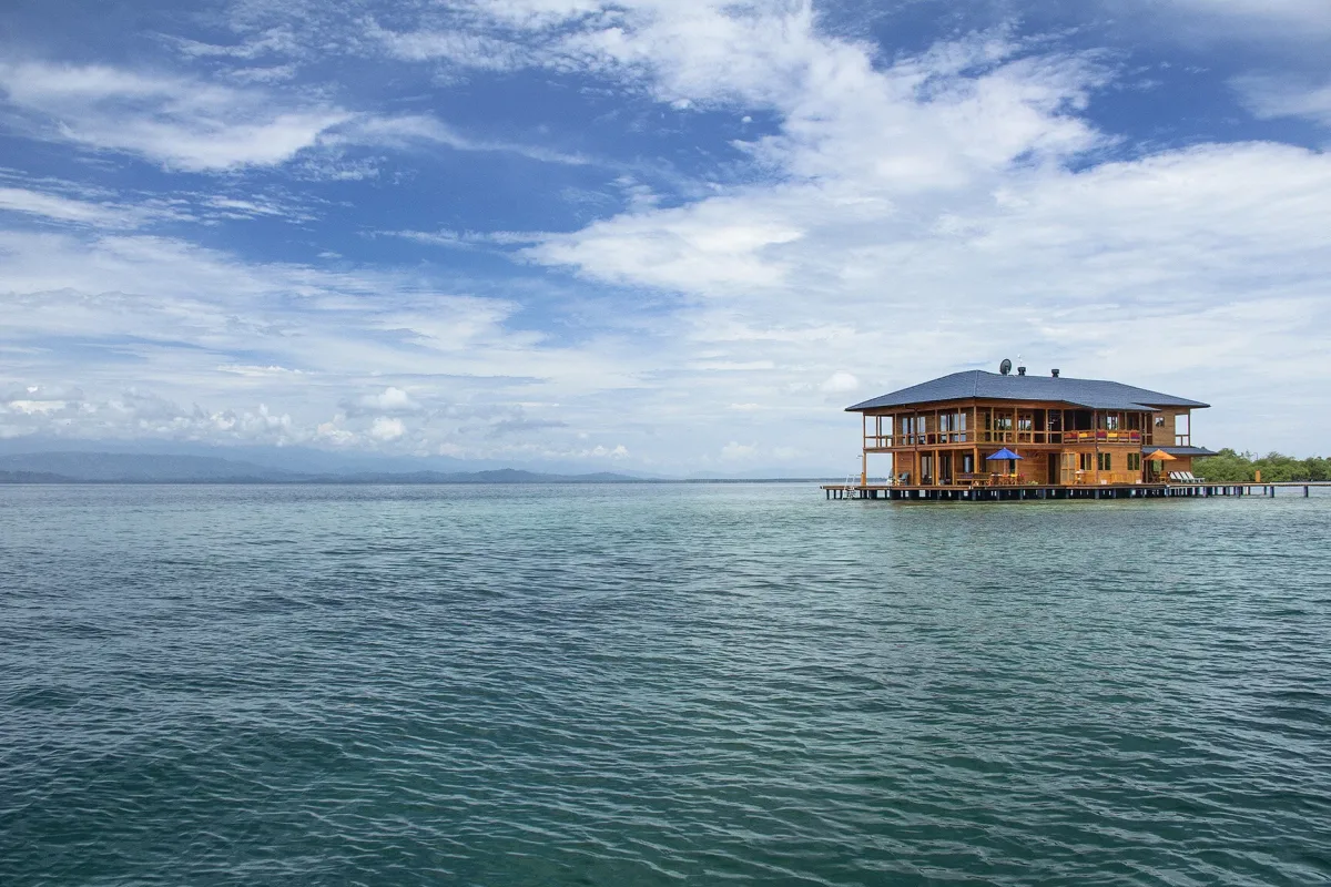 The Sweet Bocas overwater house on stilts in the turquoise water of Bocas del Toro, Panama
