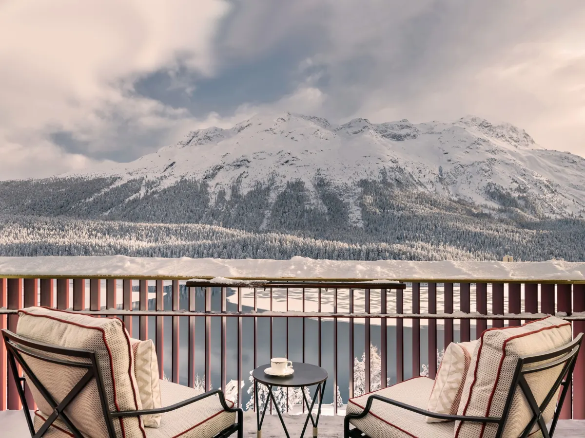 Badrutt's Palace St. Moritz suite balcony over the frozen lake in winter, a Christmas and New Year 2026 booking