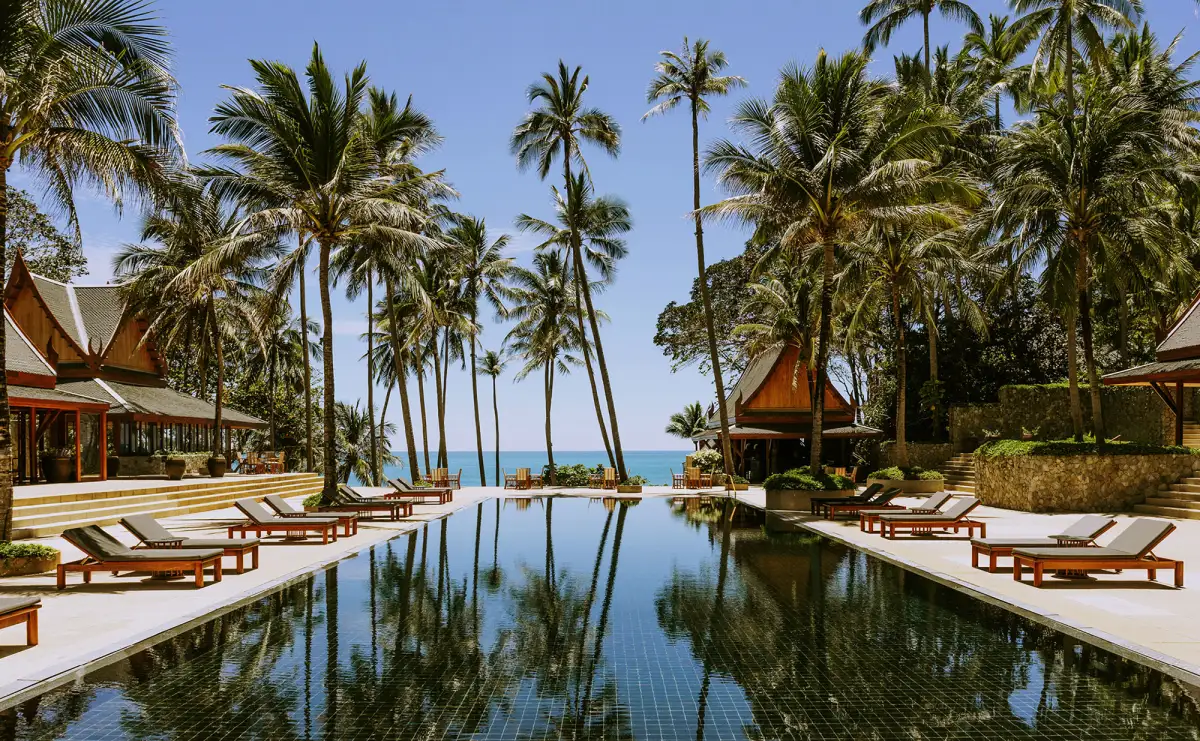 Amanpuri Phuket main pool with palms and sea, reopening September 14 2026 ahead of the festive season