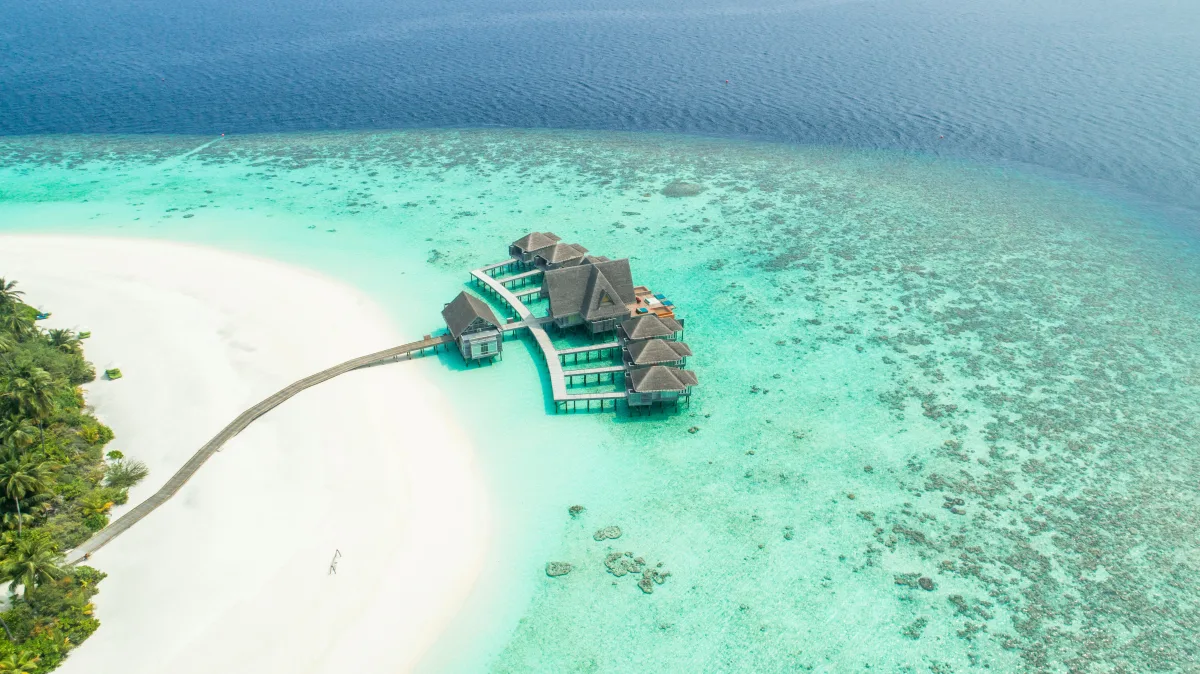 Maldives aerial view overwater villas luxury resort Indian Ocean