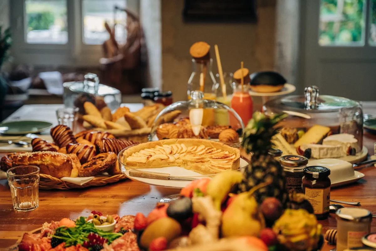 Le Logis Cognac breakfast spread with pastries tarts cheese and fruit on the estate