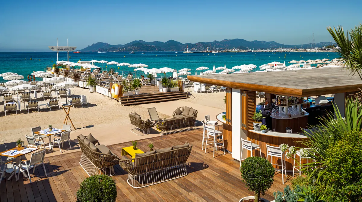 Carlton Beach Club Cannes turquoise Mediterranean white umbrellas bar terrace