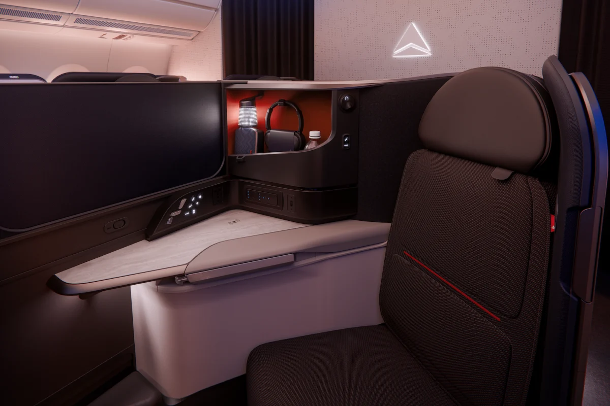 Delta One A350-1000 suite with large seatback screen console table sliding privacy door