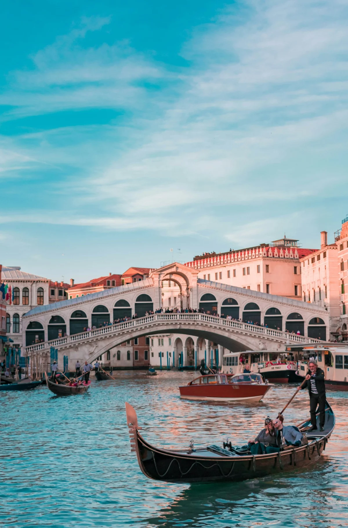 Gondolas and boats on Venice's Grand Canal near the Rialto Bridge