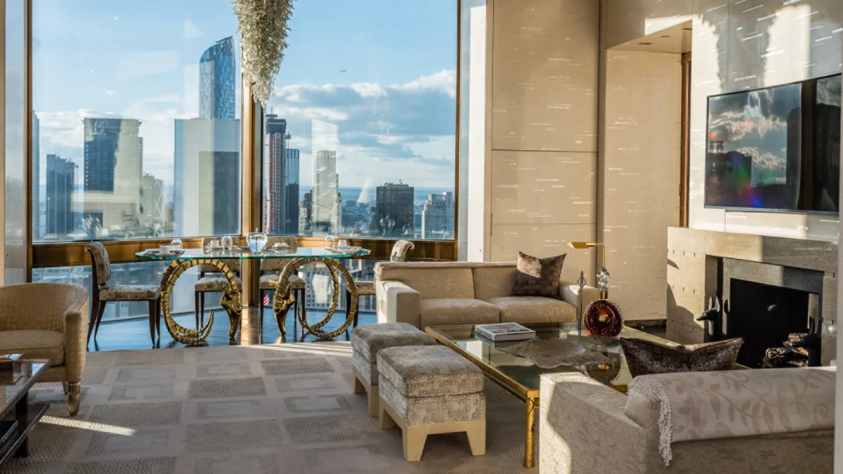 Ty Warner Penthouse Four Seasons New York living room with gold ram's head table and Manhattan skyline views