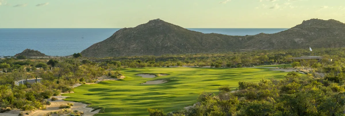 Twin Dolphin Golf Club Los Cabos fairway with Baja desert mountains and Sea of Cortez