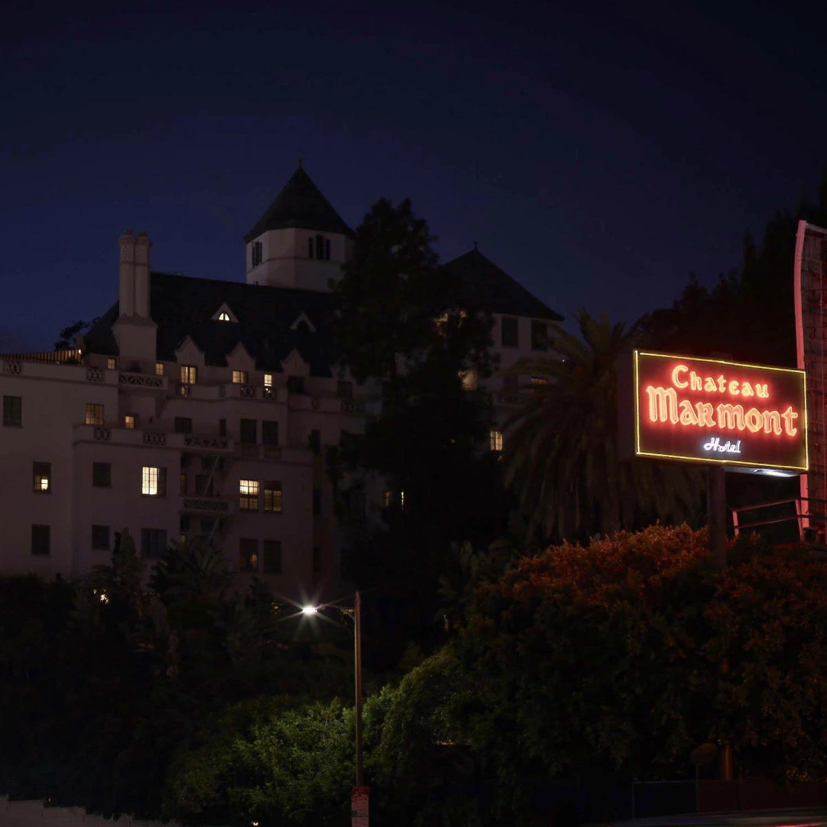 Chateau Marmont neon sign glowing against the Hollywood night sky