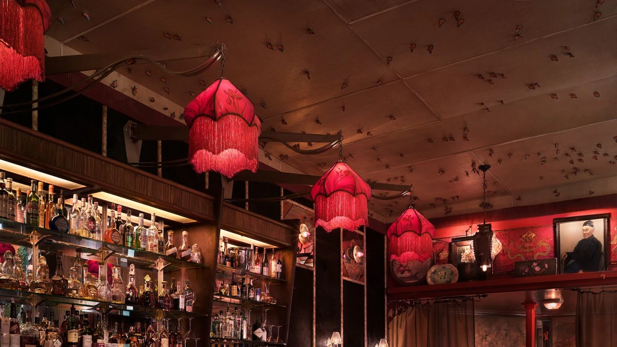 Bar Marmont interior with red fringed lamps and fully stocked bar shelves