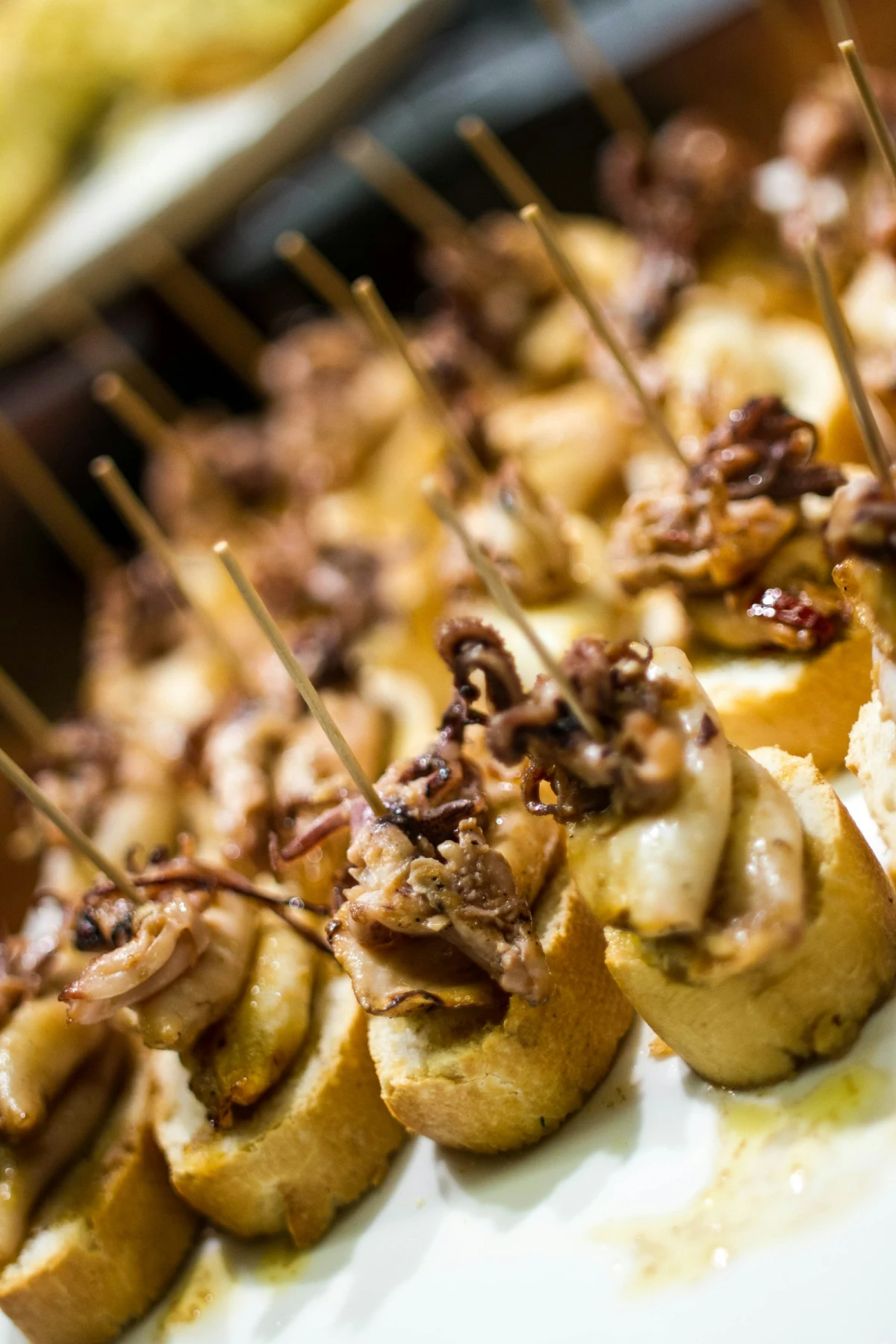 Basque pintxos on bread with skewers in a San Sebastian bar