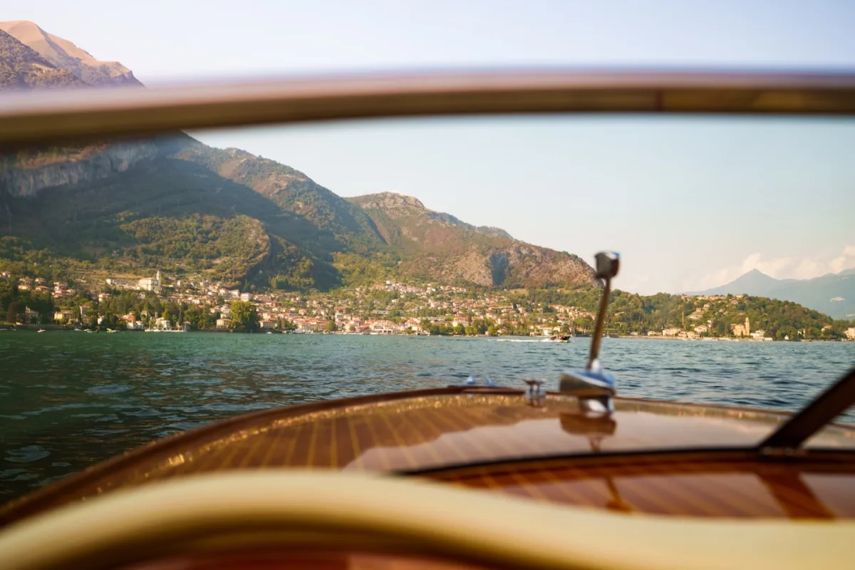 Lake Como seen from a classic wooden boat, luxury travel guide 2026