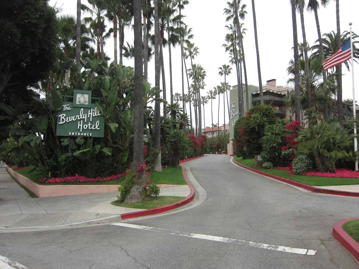 The Beverly Hills Hotel entrance sign and palm-lined driveway in California
