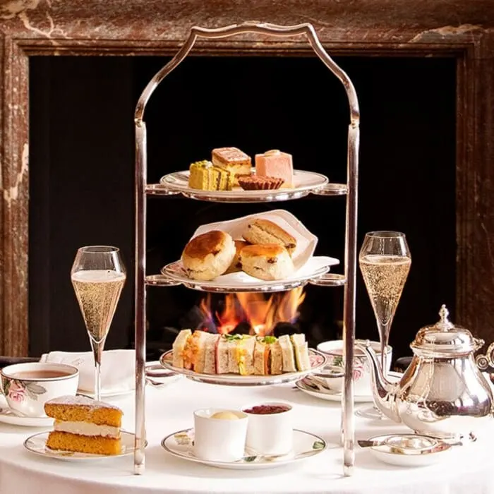 Three-tier afternoon tea by the fire in The Drawing Room at Brown's Hotel, London