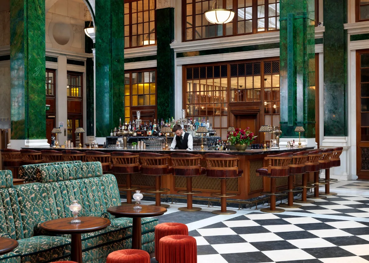 The Nickel Bar in the grand former banking hall at The Ned in the City of London, ringed by green verdite columns
