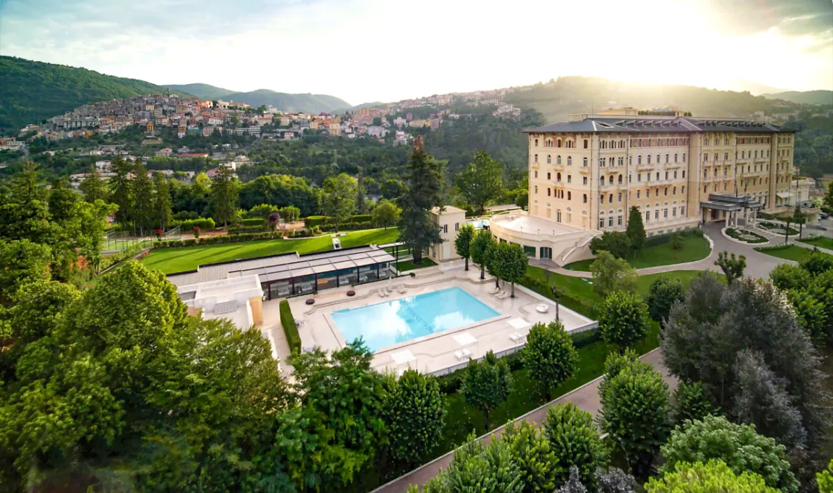 Aerial view of Palazzo Fiuggi and its pool above the hilltop town of Fiuggi, Italy