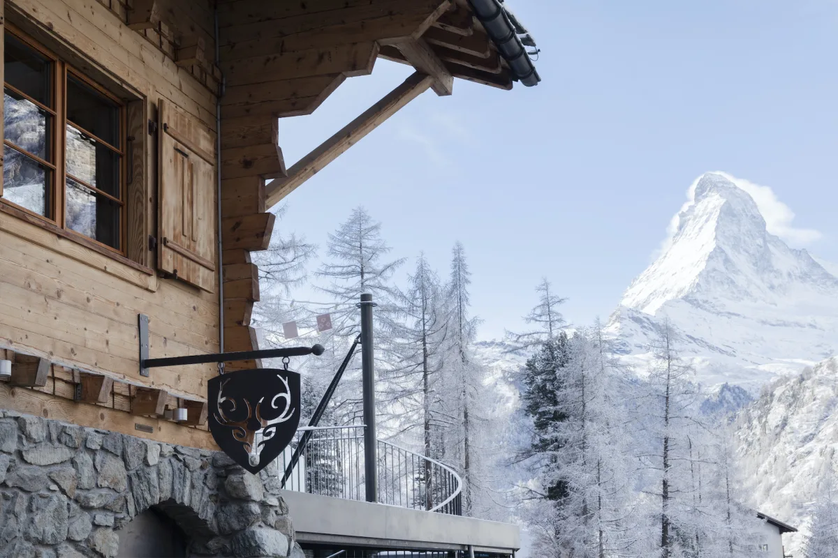 CERVO Mountain Resort chalet with its stag emblem and the Matterhorn behind