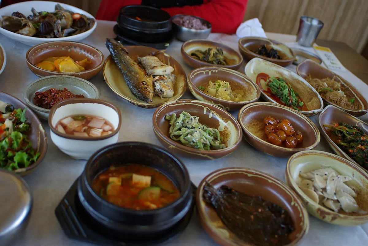 A Korean table set with banchan side dishes, grilled fish and stew, the format behind Seoul's hansik restaurants