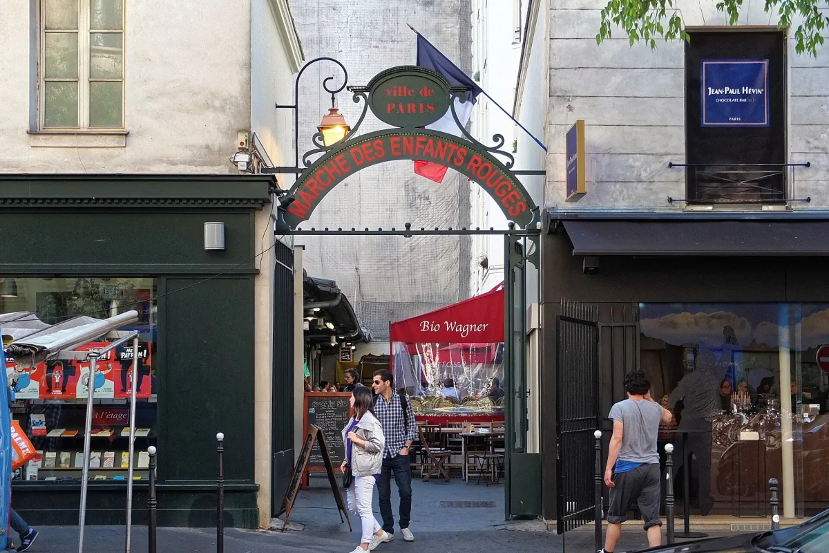 The wrought-iron entrance arch of the Marche des Enfants Rouges on rue de Bretagne in the Marais, Paris