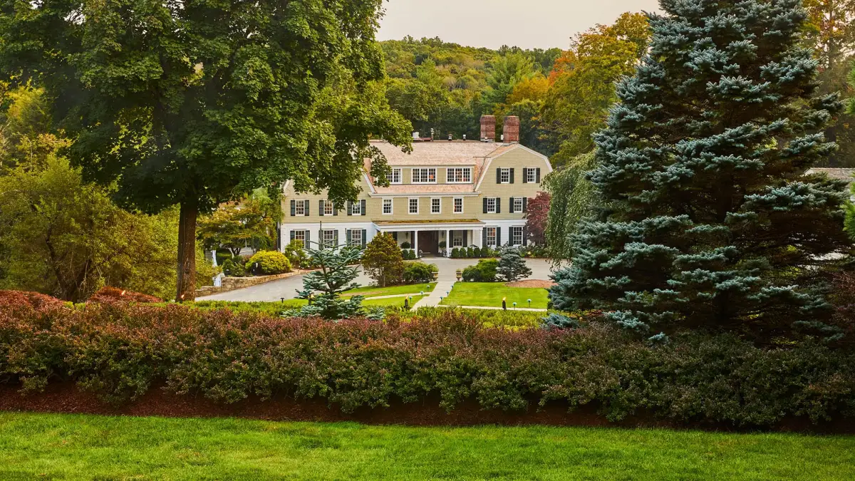 Mayflower Inn and Spa, Auberge Collection, in Washington, Connecticut, surrounded by fall trees in the Litchfield Hills