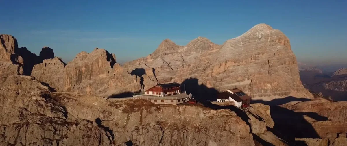 Rifugio Lagazuoi on its ridge at 2,752 metres above the Falzarego pass in the Dolomites at dawn