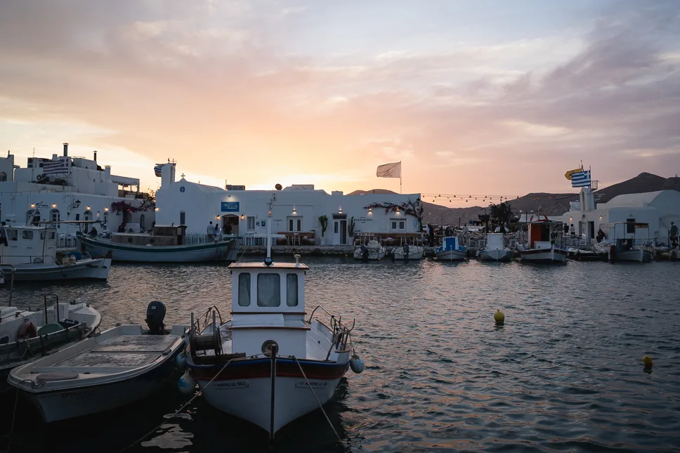 Naoussa harbor Paros Cyclades Greece at sunset with fishing boats and whitewashed village