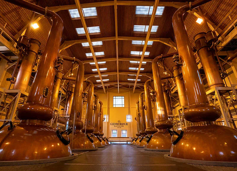 Copper stills inside a Scottish whisky distillery