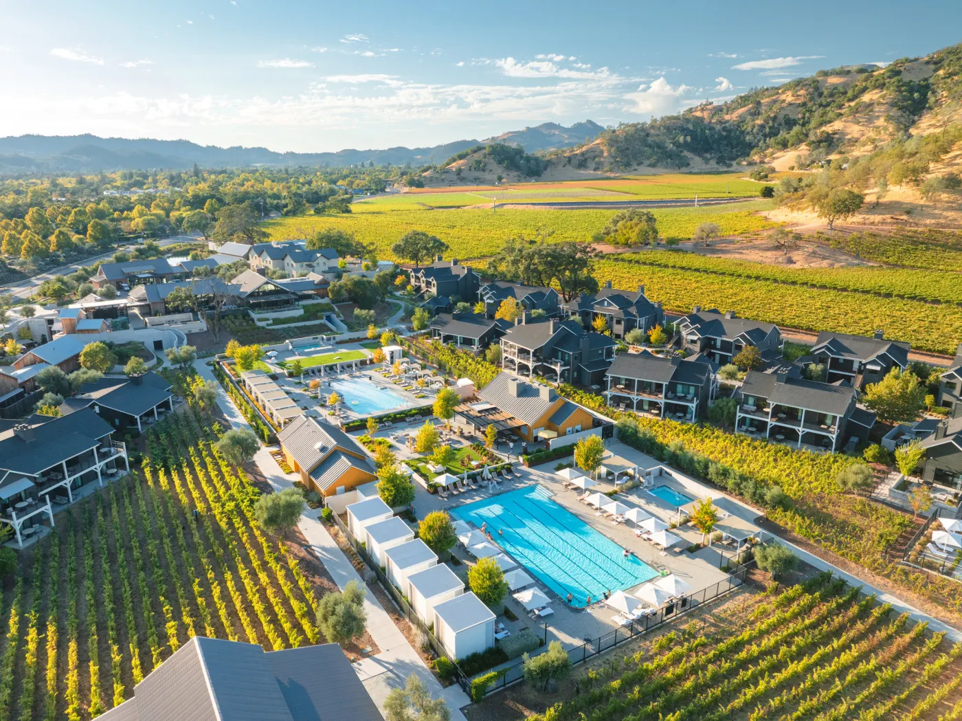 Aerial view of a Napa Valley luxury wine country resort surrounded by vineyards and mountains