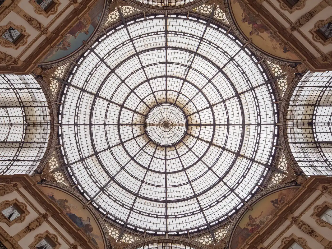 The glass-and-iron dome of the Galleria Vittorio Emanuele II in Milan, seen from below