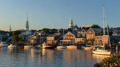 Nantucket harbor at golden hour, with the grey-shingled historic town along the waterfront