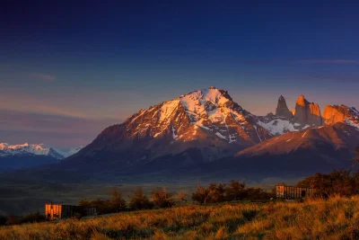 The granite towers of Torres del Paine glowing at sunrise above Awasi Patagonia's villas, the heart of luxury Patagonia travel