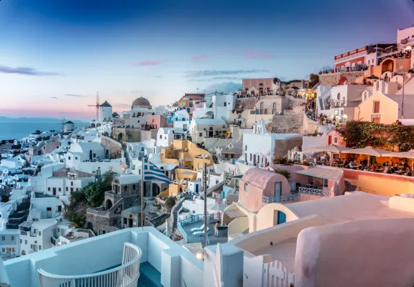 Santorini Oia village at dusk with white Cycladic houses caldera views Greek Islands summer 2026