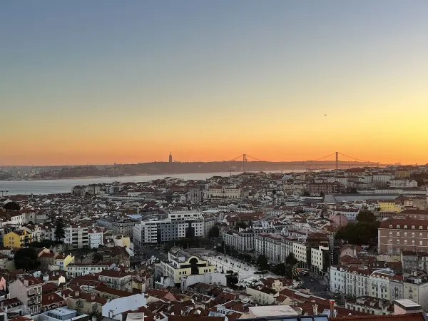 Lisbon skyline at sunset with the 25 de Abril bridge and the Tagus river, the start of a night out