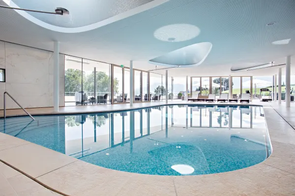 The indoor pool at Clinique La Prairie overlooking Lake Geneva, among the best longevity retreats in Europe