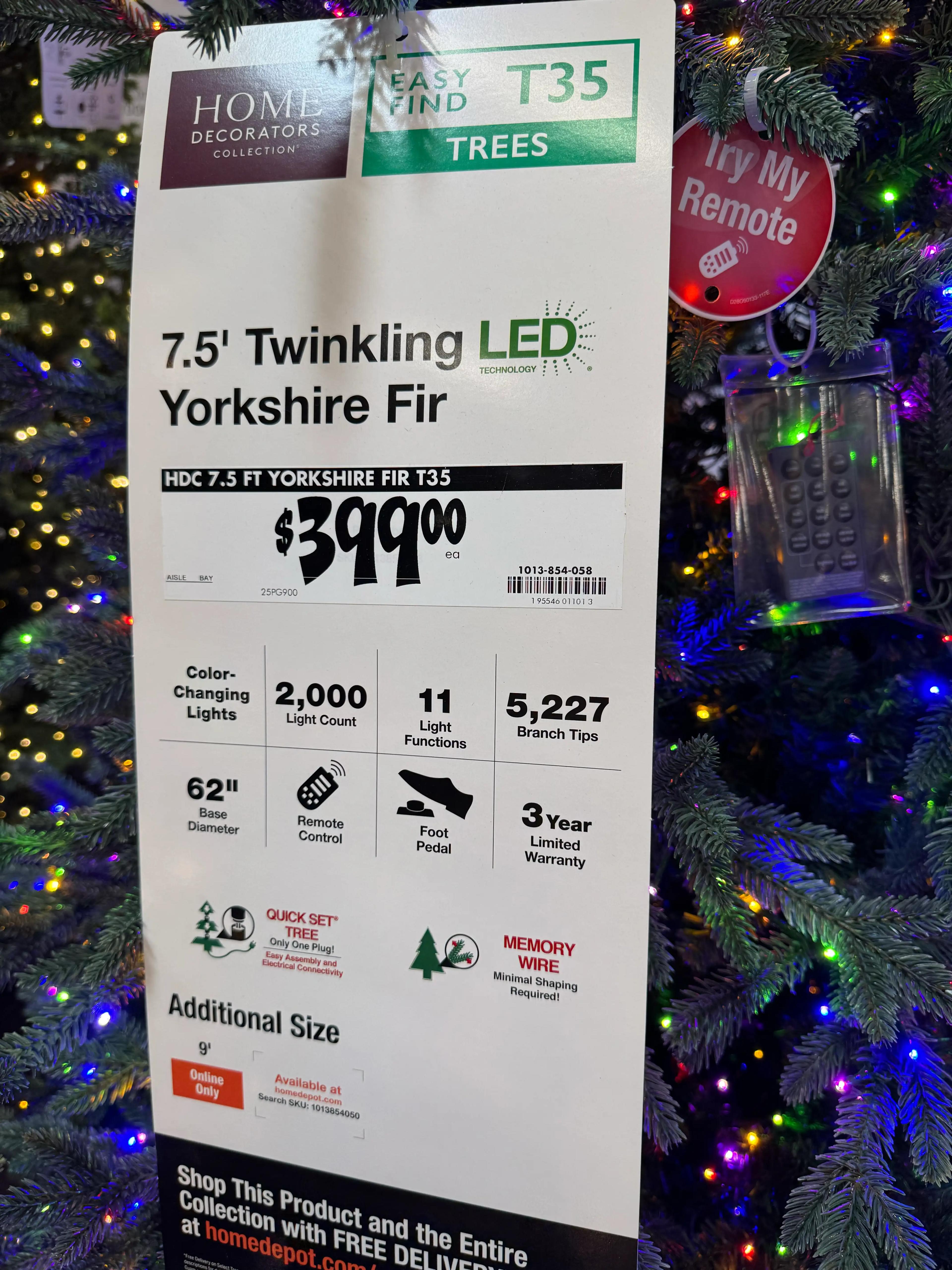 Product sign showing 7.5ft Yorkshire Fir specs: 2,000 lights, 11 functions, 5,227 tips, remote control, $399