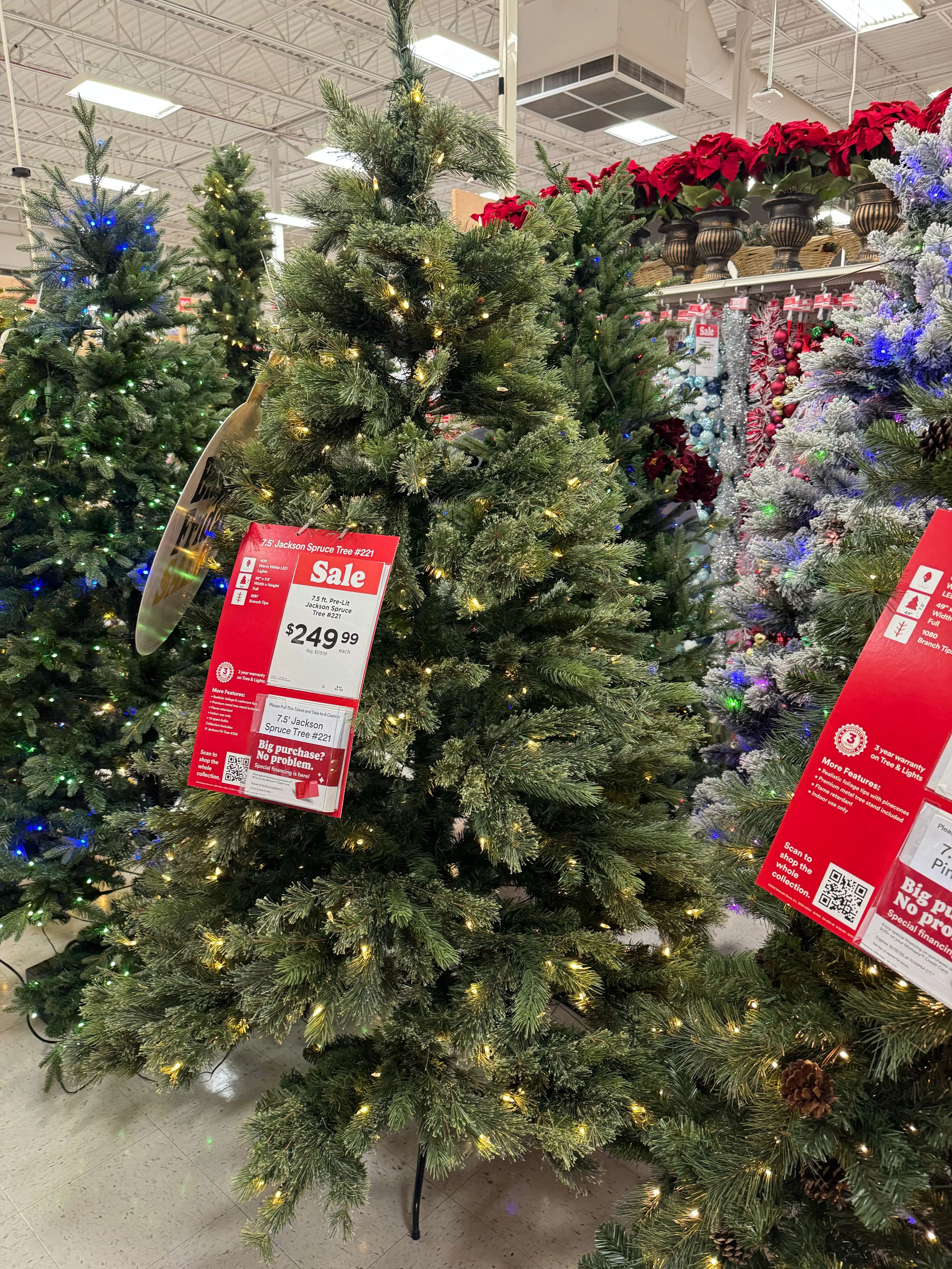 Full spruce-style tree with mixed PVC/PE needles, moderate density with some gaps, warm white LED lights throughout