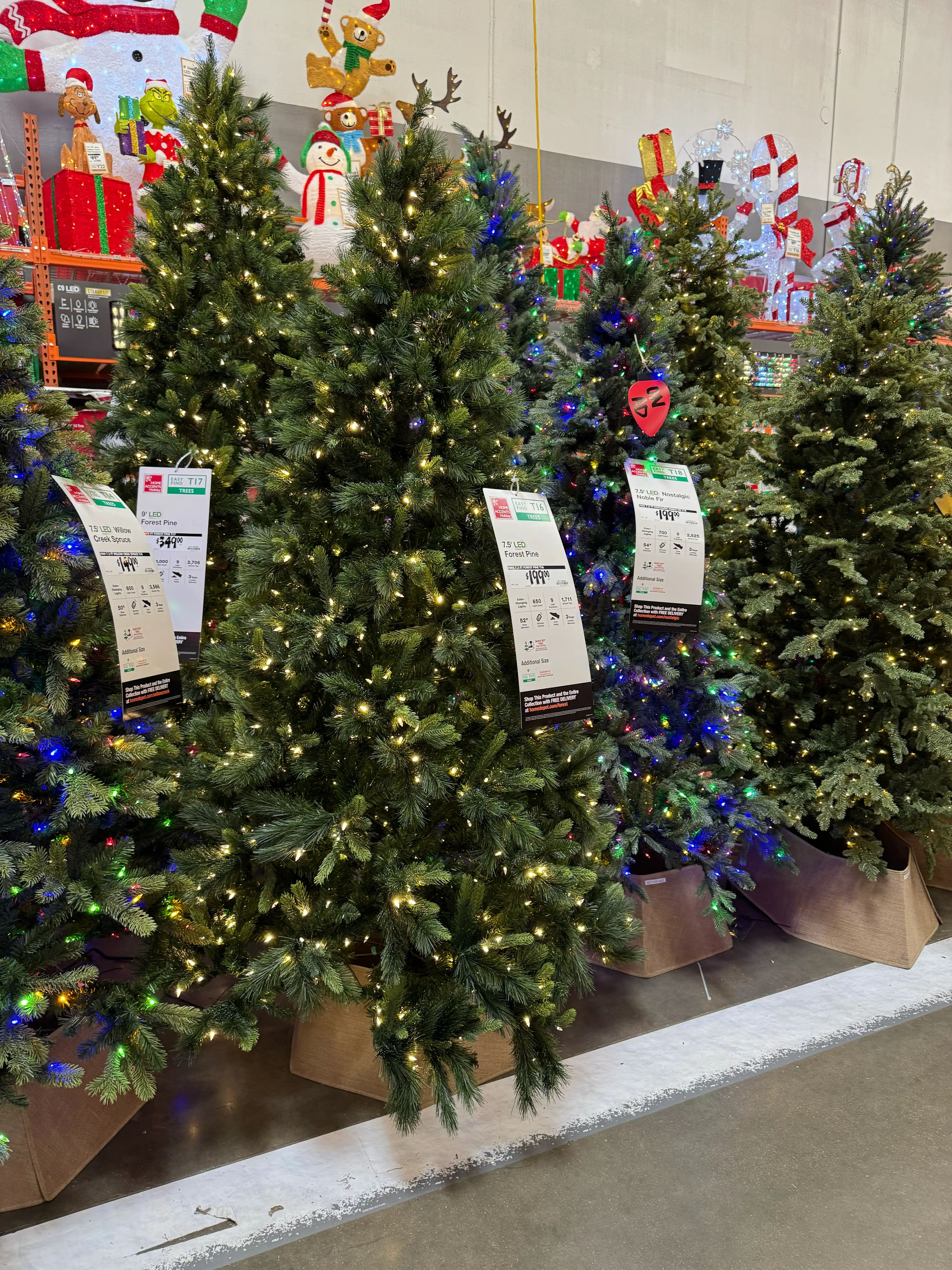 Dense PVC pine trees with full branching, warm white LED lights throughout, minimal gaps, traditional shape