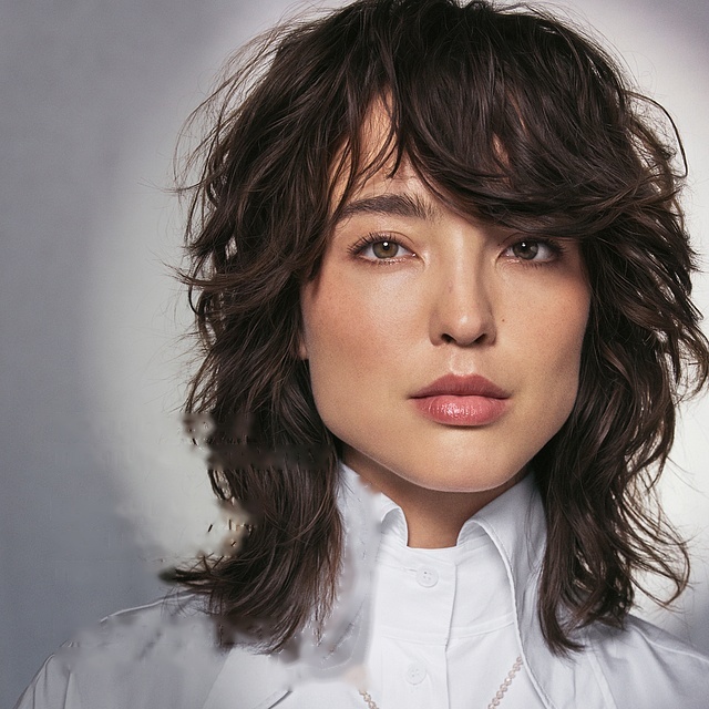 Aveda model with soft, lived-in textured waves — result of Tousle Texture Dry Spray