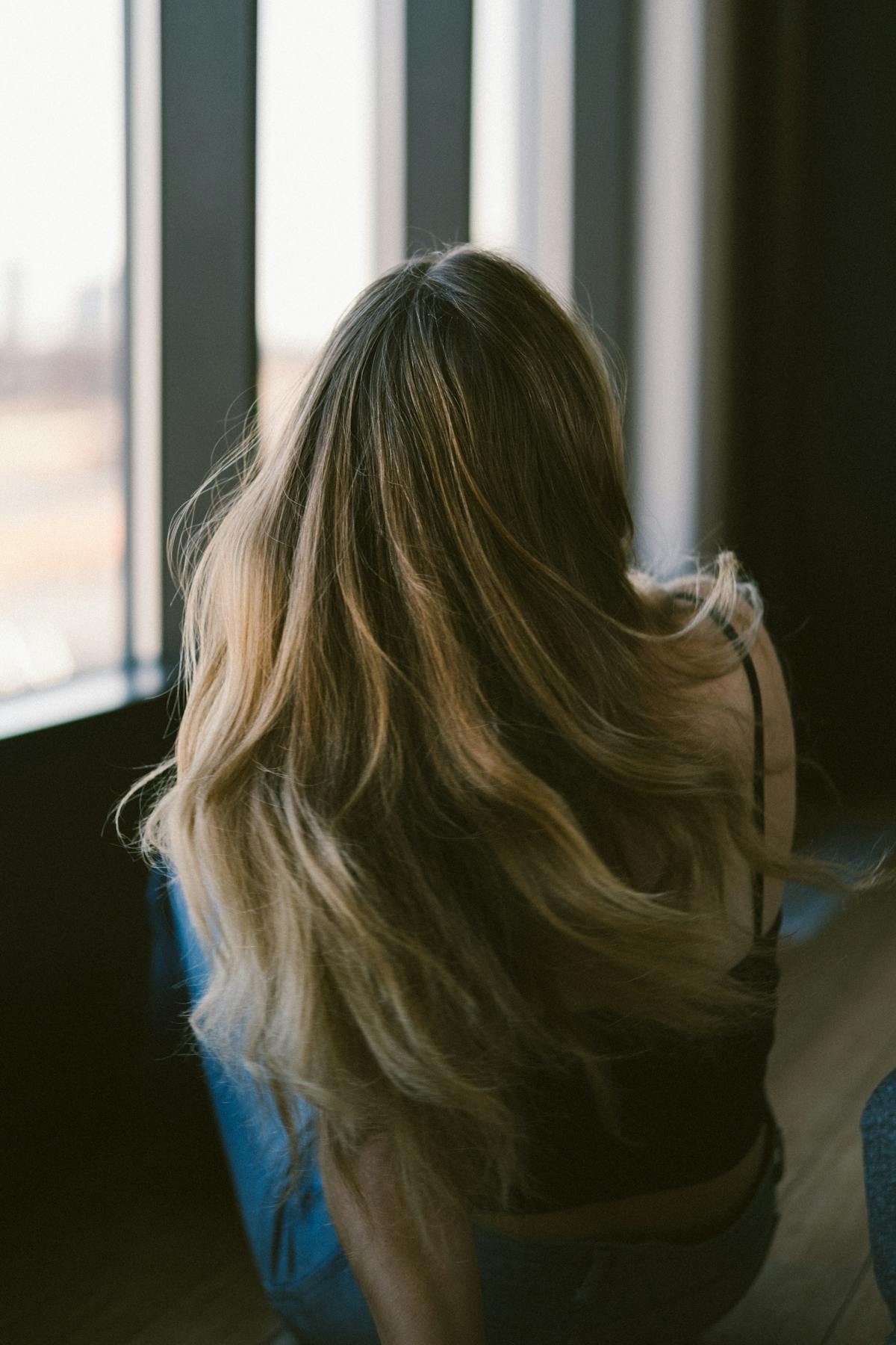 Woman with long sun-kissed blonde hair in natural light