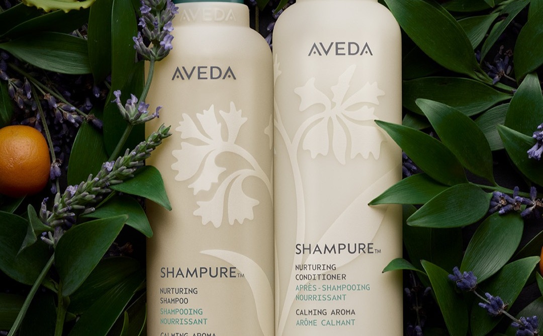 Aveda Shampure bottles nestled in fresh lavender and greenery