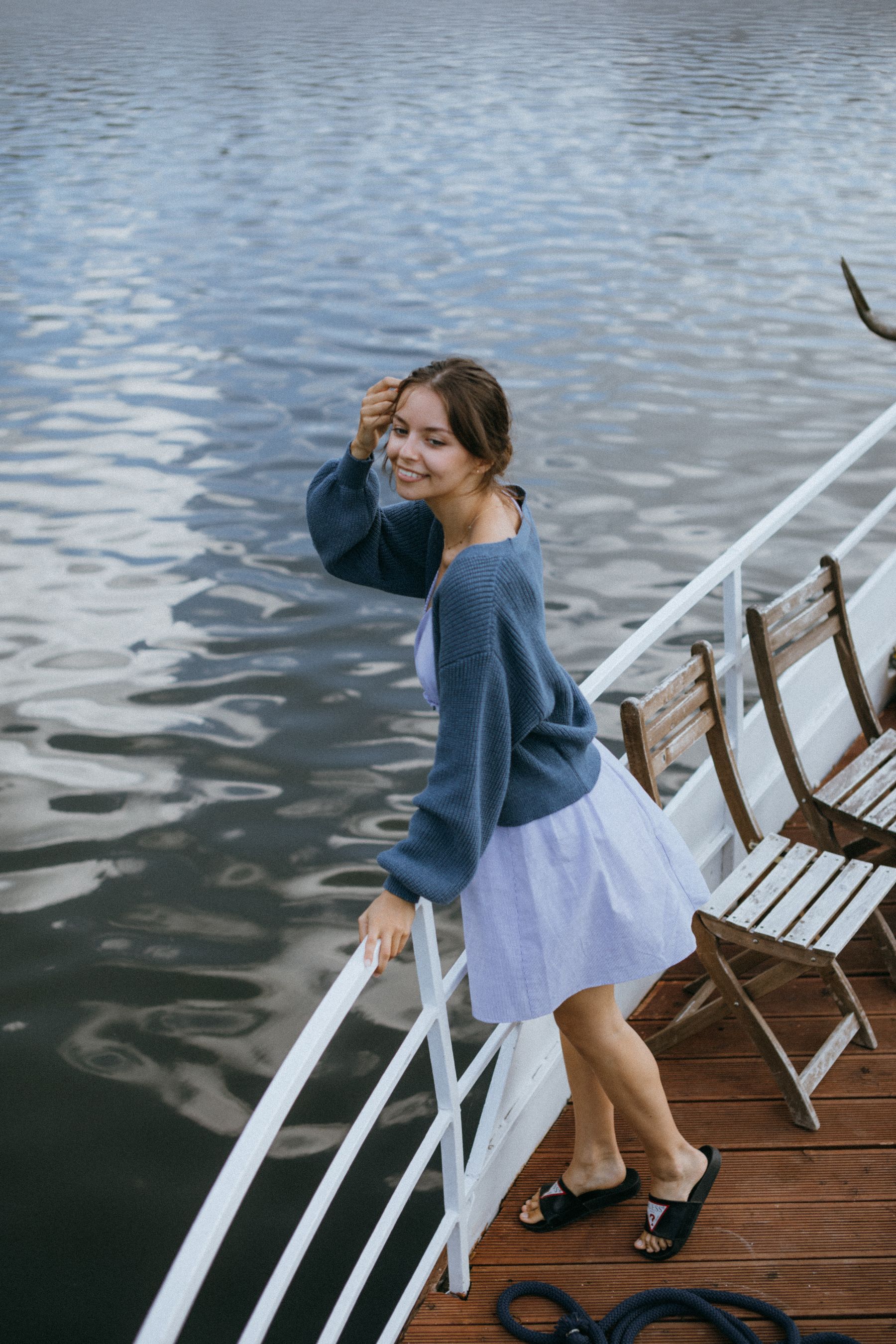 Woman on a boat at Lake Travis with sun in her hair on a bright summer afternoon
