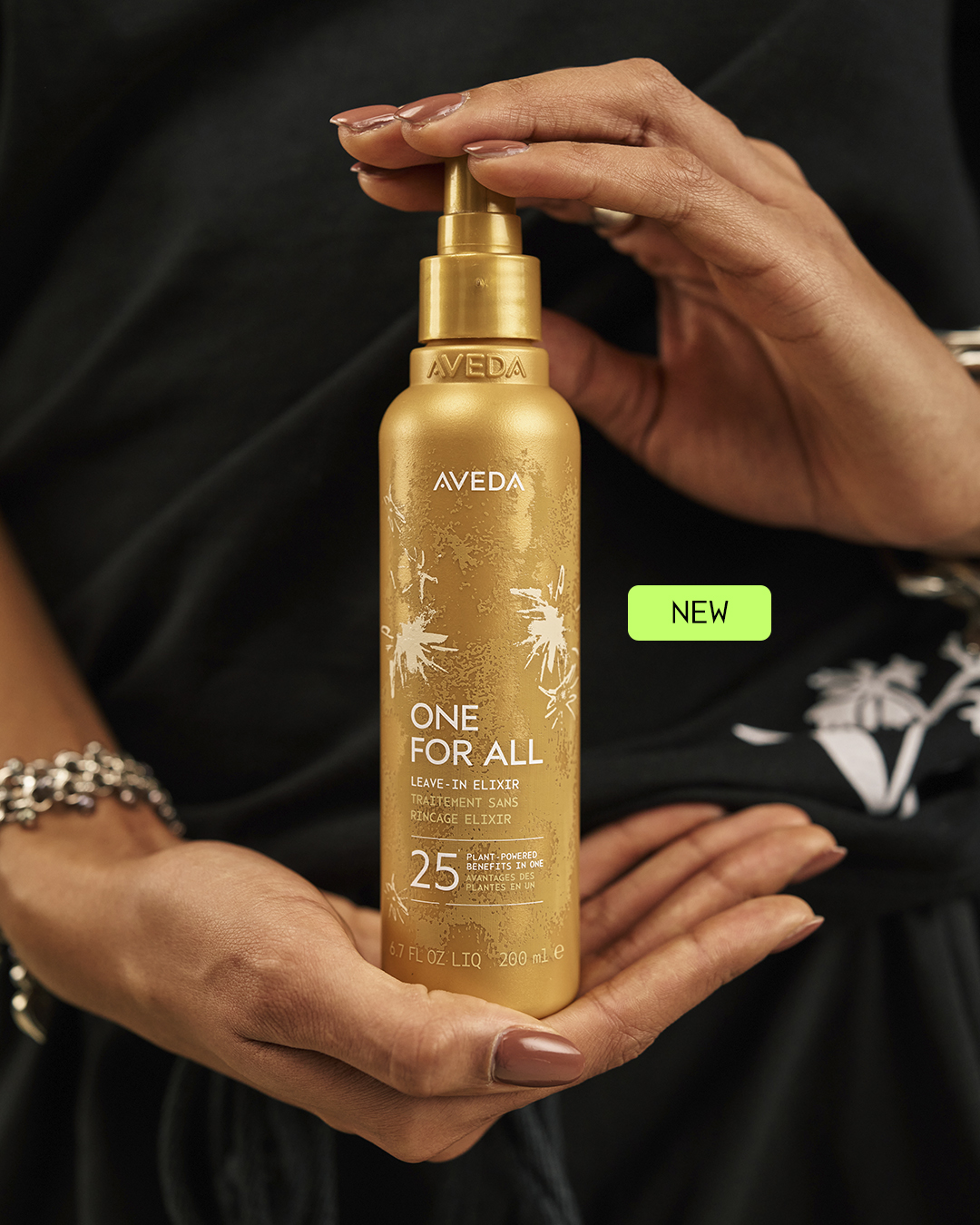 Aveda One For All Leave-In Elixir held in hand, 25 plant-powered benefits