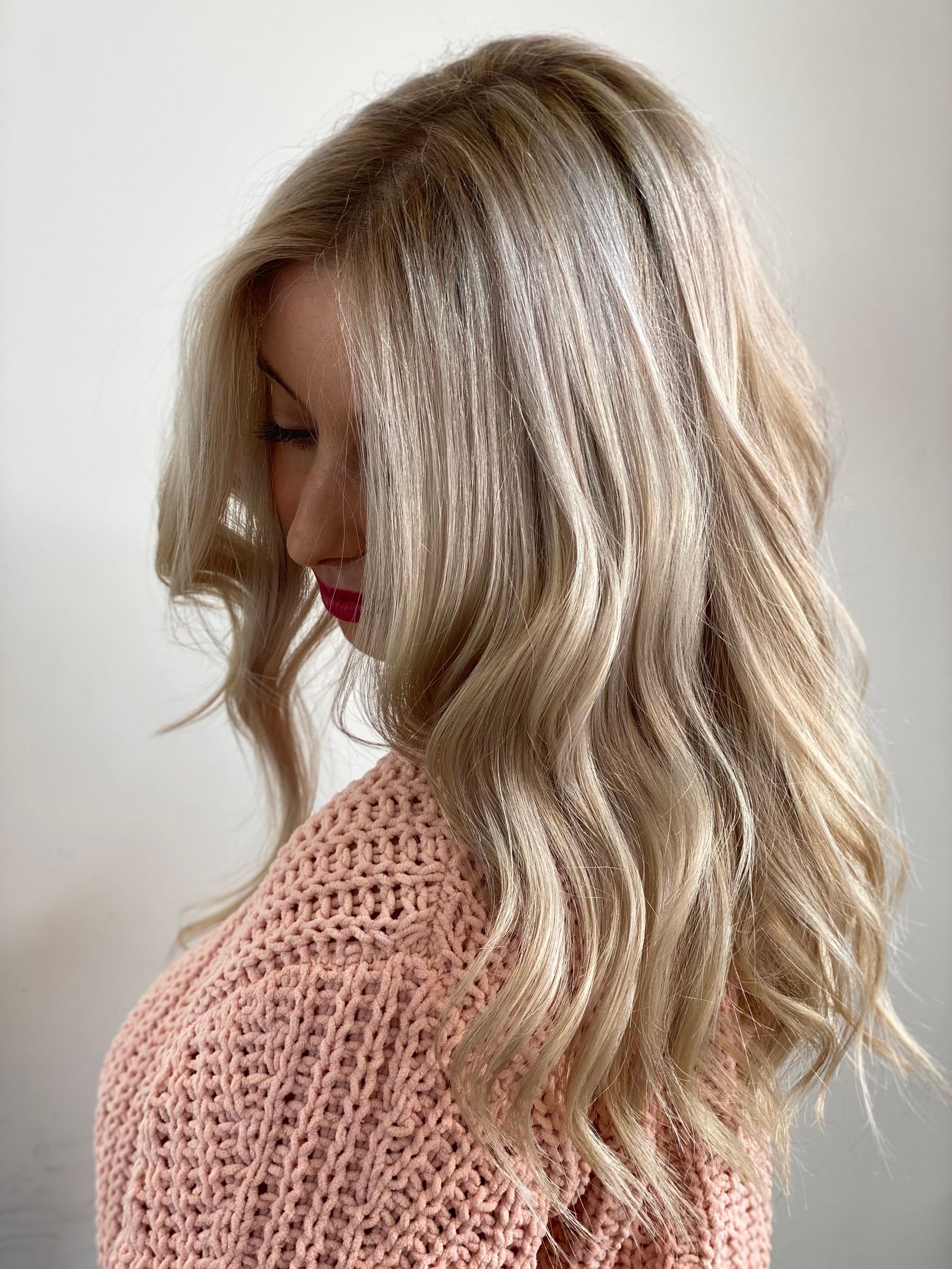 Soft toned blonde waves catching the light after a toning service