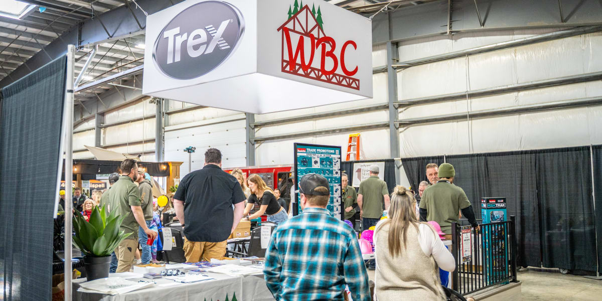 A bustling trade show booth for Western Building Center (WBC) at what appears to be a 2025 Home and Garden Show