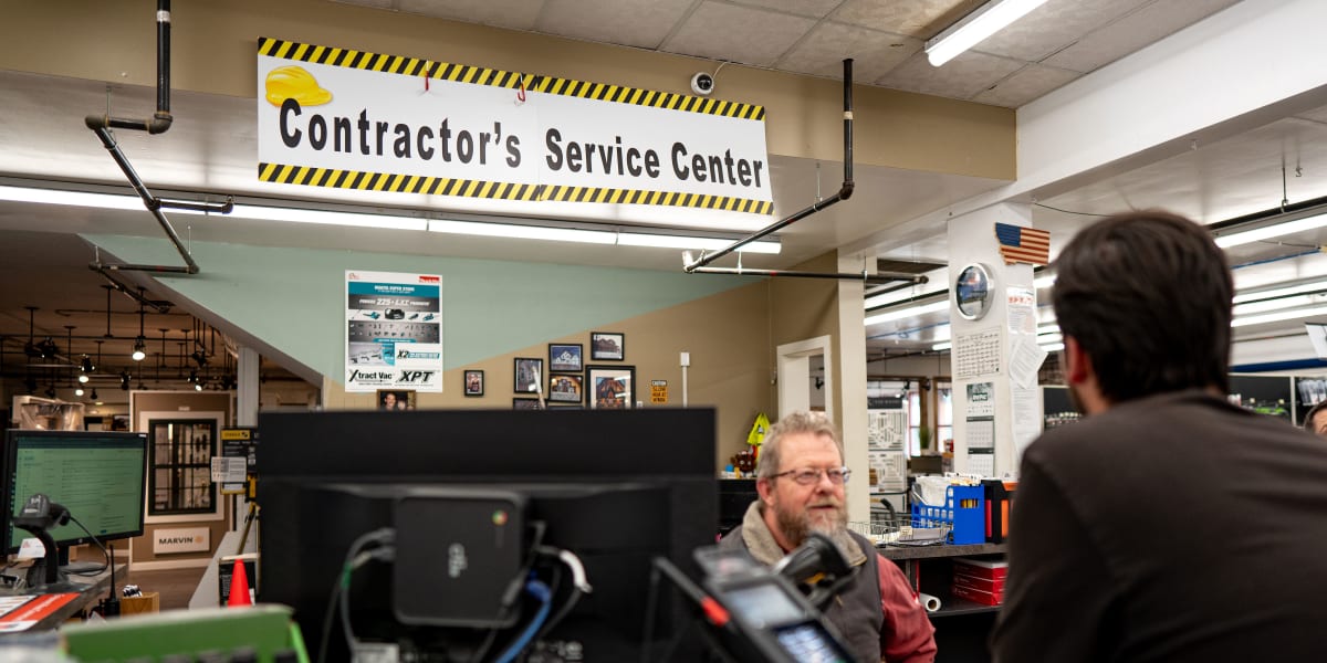 Interior view of the Contractor's Service Center within Western Building Center, showing employees and customers interacting