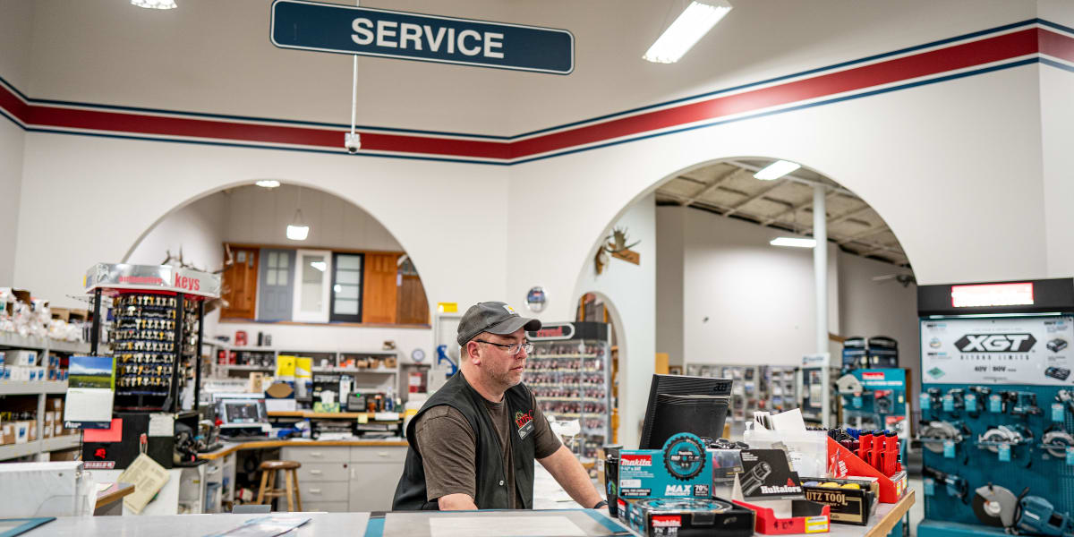 Interior view of the service counter area at Western Building Center, showing an employee in glasses and cap working behind a