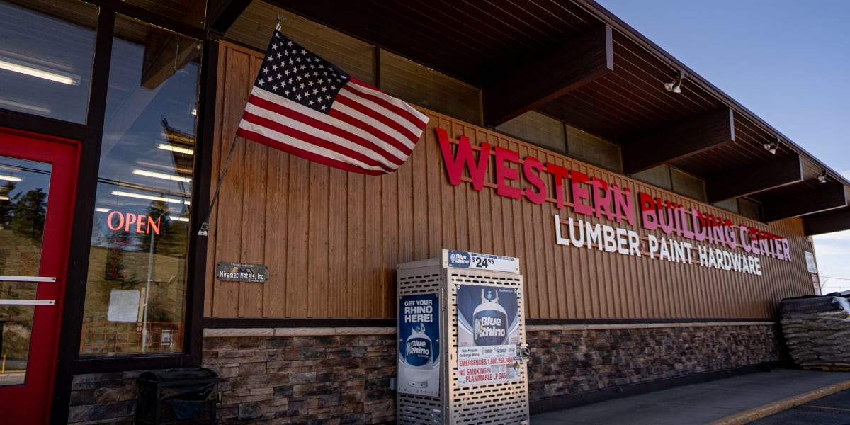 Exterior storefront view of Western Building Center showing the main entrance with red doors and an 'OPEN' sign