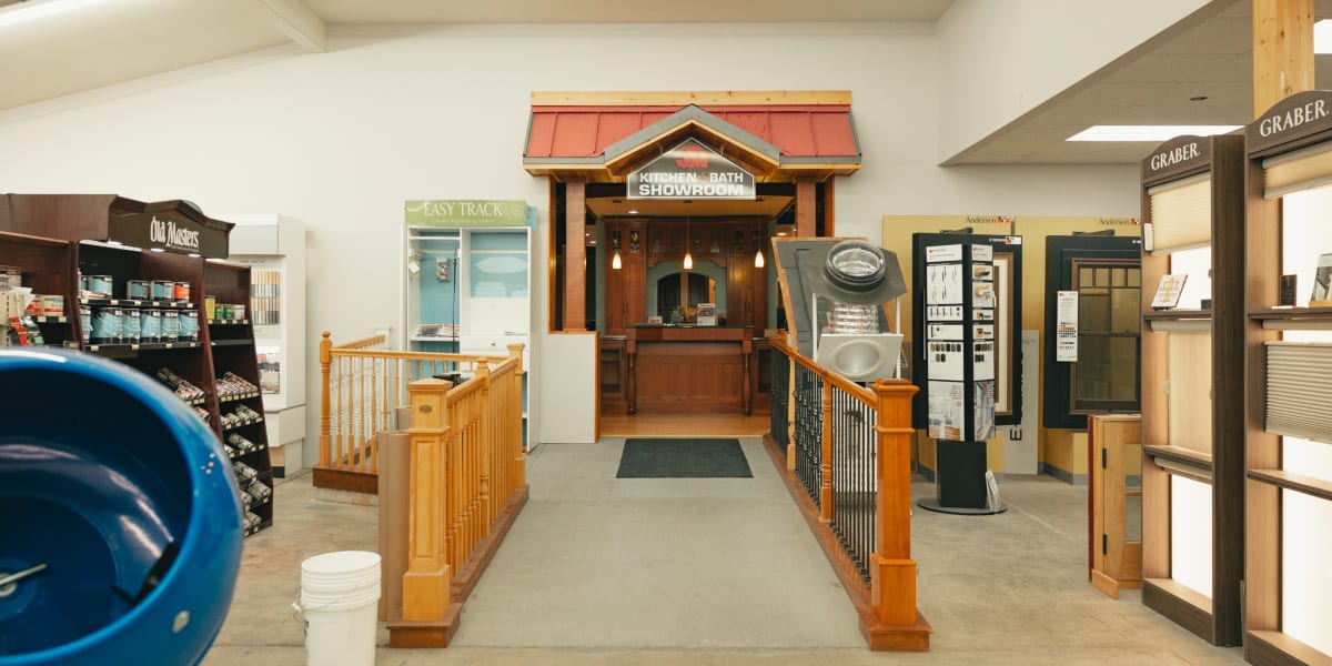 Interior showroom of a building supply store featuring multiple product display areas and departments