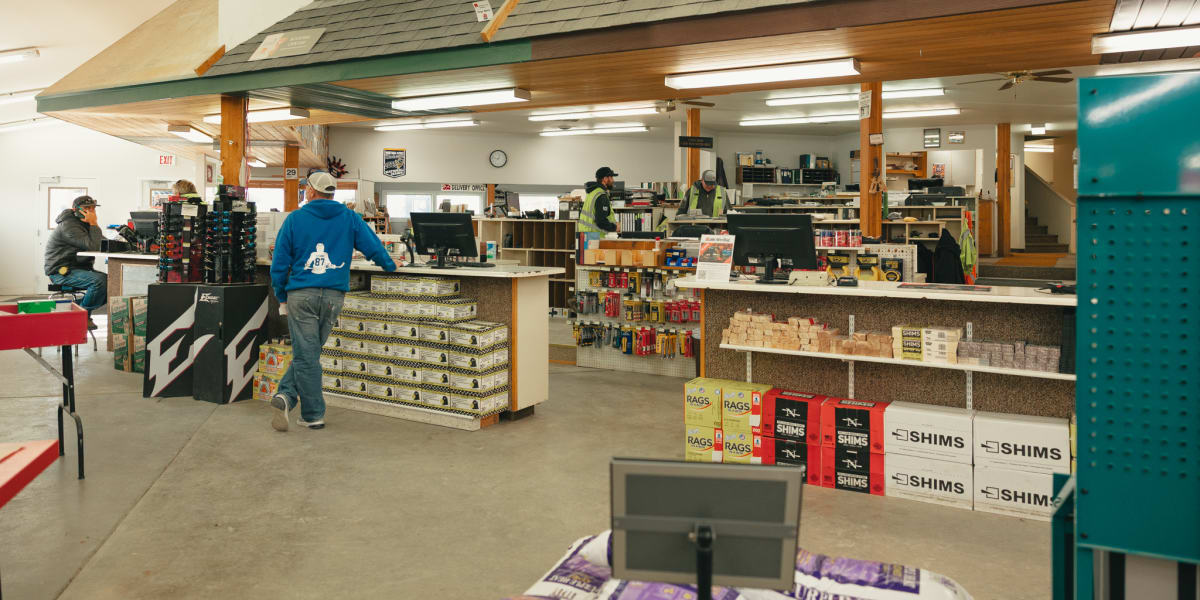 Interior view of a Western Building Center store showing the main retail floor with a distinctive overhead roof structure fea