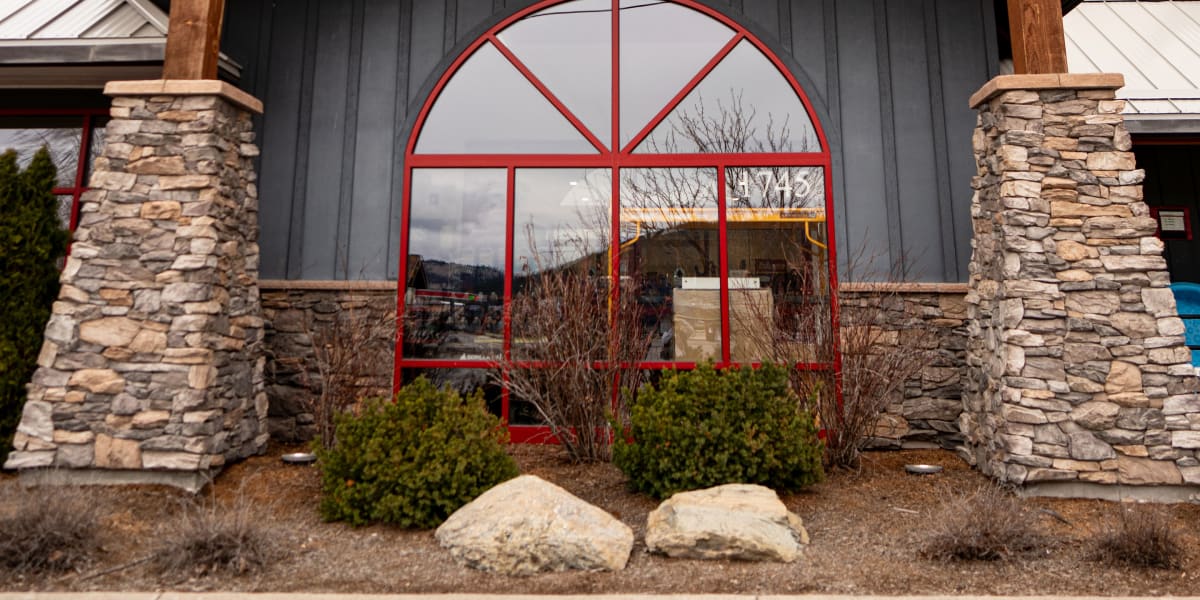 This image shows the exterior entrance of a rustic building with distinctive architectural features including exposed wooden