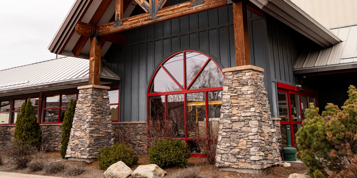 The exterior entrance of the Western Building Center Kalispell location, featuring a distinctive architectural design with ex