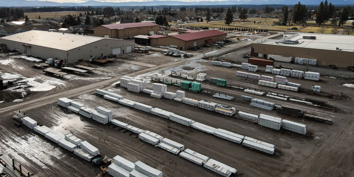 Aerial view of Western Building Center's corporate yard facility showing multiple warehouse buildings with tan walls and red
